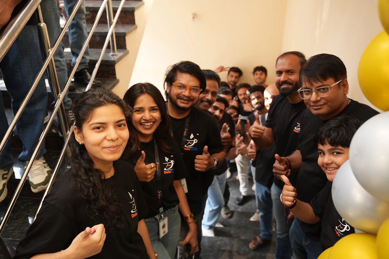 The team cheering together in DataCaffé t-shirts